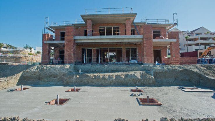 Stage 7: Exterior walls and roof complete, work on the interior and pool begins