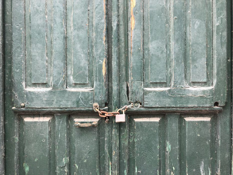 squatters in spain green door with padlock